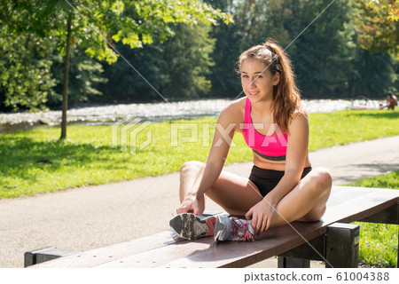 Portrait of young fit woman outdoors 61004388