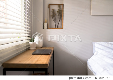 Workplace near the window with laptop and Workplace near the window with laptop and 61005058
