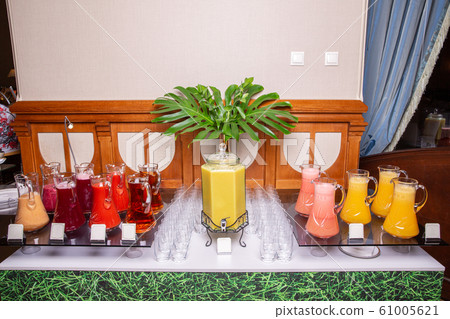 Table with spilled juices in pitchers at the hotel breakfast 61005621