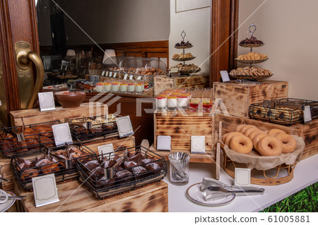 Dessert table with cookies and doughnuts 61005881