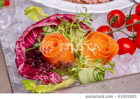 Vegetables as flower composition in ice 61005883