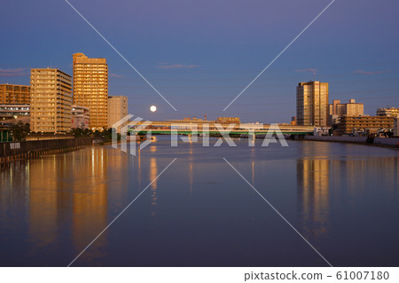 View of Okubashi from Kodaibashi at dusk with the typhoon passing Sumida River and full moon 61007180