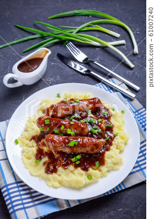 Bangers and Mash with Onion Gravy on a plate 61007240
