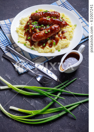 Bangers and Mash with Onion Gravy on a plate Bangers and Mash with Onion Gravy on a plate 61007241