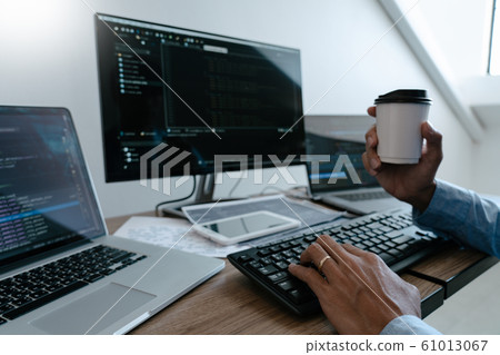 Programmer working On Computer In IT Office Typing 61013067