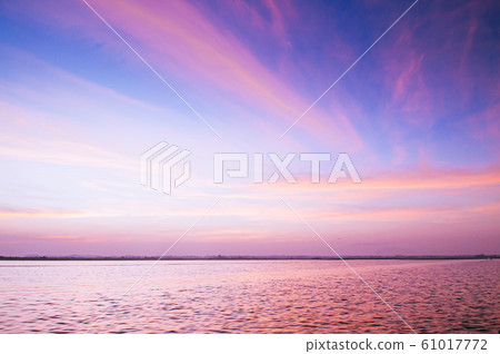 Beautiful burning dramatic sunrise or sunset sky over wide peaceful Nong Harn lake, Udonthani - Thailand. 61017772