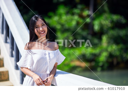 Close-Up Portrait Of Beautiful Asian Smiling Girl Close-Up Portrait Of Beautiful Asian Smiling Girl 61017910