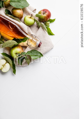 Apple cider vinegar and fresh apples, flat lay, space for your text 61019076