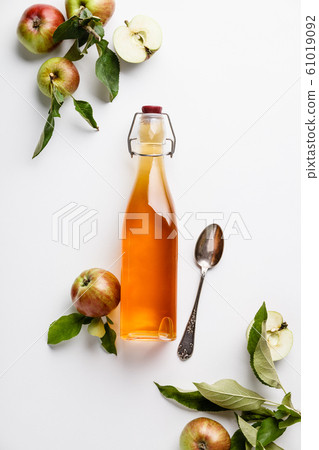 Apple cider vinegar and fresh apples, flat lay, space for your text 61019092