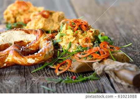 Bavarian cheese specialty - so called obatzda - served with a pretzel Bavarian cheese specialty - so called obatzda - served with a pretzel 61021088