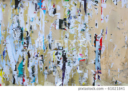 Dirty street yellow wall with old torn and peeling 61021841