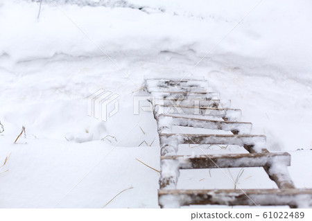 Winter, wooden stairs on the street, covered with 61022489