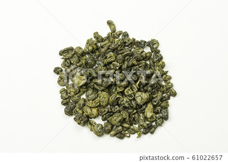 rolled green tea leaves on a white background rolled green tea leaves on a white background 61022657