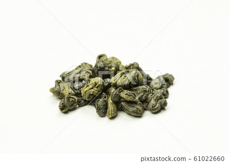 rolled green tea leaves on a white background 61022660
