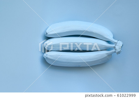 Blue bananas on a blue background. Minimal style 61022999