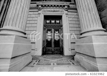 Massive ancient roman columns with wooden door Massive ancient roman columns with wooden door 61023962