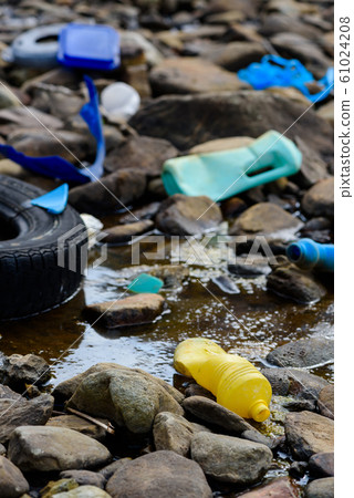 Plastic waste garbage pollution in dirty oily water on ocean shore Plastic waste garbage pollution in dirty oily water on ocean shore 61024208