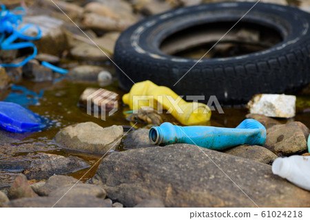Environment pollution. Old tire bottles and plastic trash on ocean shore. Environment pollution. Old tire bottles and plastic trash on ocean shore. 61024218