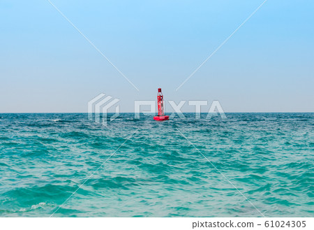 Red Buoys are Floating in the Green Blue Sea 61024305