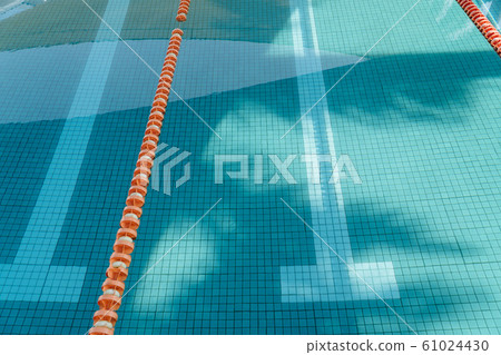 Top view of cyan swimming pool. Blue pool with sunlight in campus of a school Top view of cyan swimming pool. Blue pool with sunlight in campus of a school 61024430