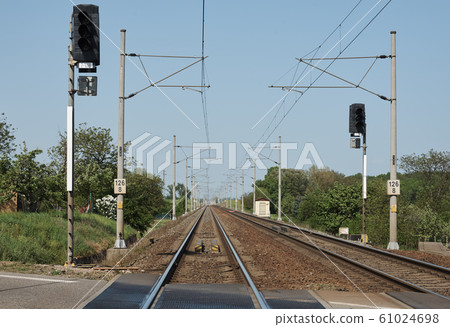 Train tracks with columns, electric wires and Train tracks with columns, electric wires and 61024698