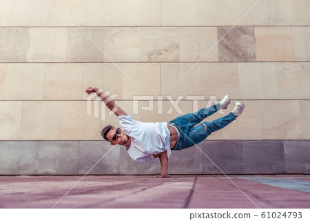 Superman flight, man acrobat dancer, handstand, dancing breakdance, summer city, free space text, hip hop dancer. Youth lifestyle, active, trend modern, fitness sport, positive motivation. Superman flight, man acrobat dancer, handstand, dancing breakdance, summer city, free space text, hip hop dancer. Youth lifestyle, active, trend modern, fitness sport, positive motivation. 61024793