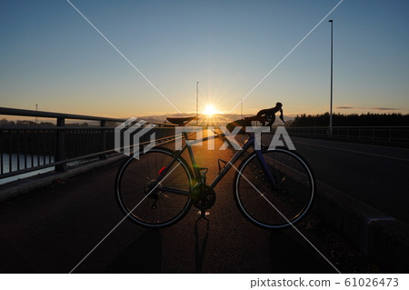 First sunrise and road bike First sunrise and road bike 61026473