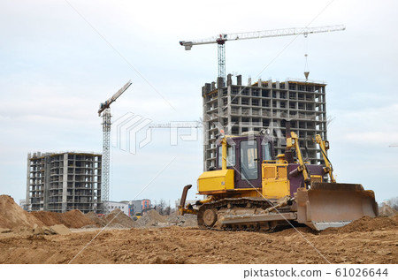 Bulldozer during of large construction jobs at building site. Bulldozer during of large construction jobs at building site. 61026644