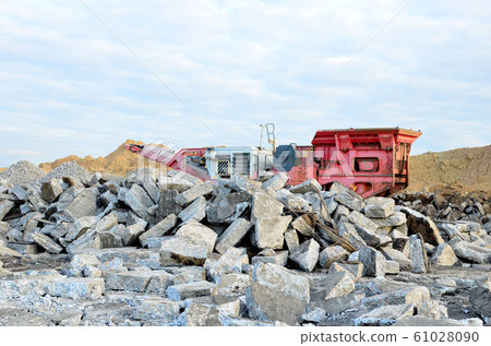 Mobile Stone crusher machine by the construction site or mining quarry for crushing old concrete slabs Mobile Stone crusher machine by the construction site or mining quarry for crushing old concrete slabs 61028090
