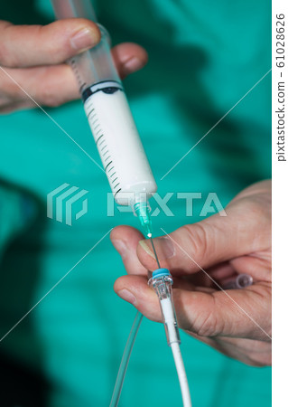 Surgical team preparing their patient for surgery, anesthesiologist gives anesthesia to a patient 61028626