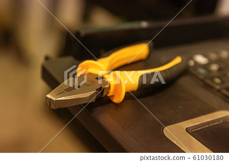 work tool yellow black cutting pliers close-up on 61030180