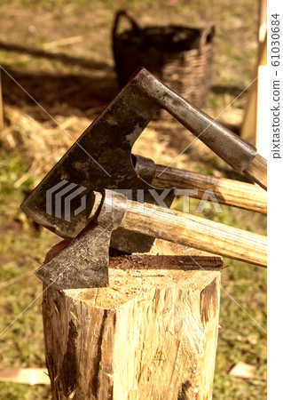 iron ax stuck into a log old traditional weathered 61030684