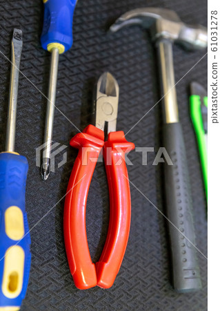 pair of screwdrivers, nippers with red handles and 61031278
