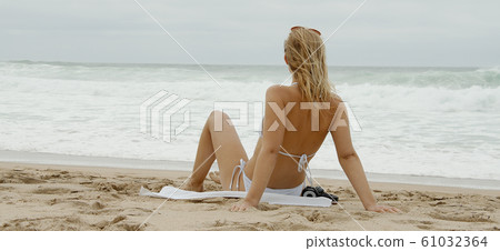 Young and sexy woman at the beach 61032364