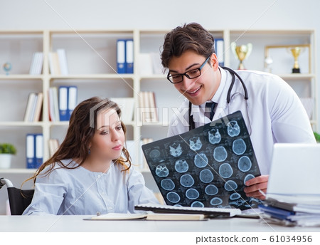 Doctor explaining to patient results of x-ray imaging 61034956