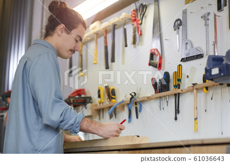 Worker working in workshop Worker working in workshop 61036643