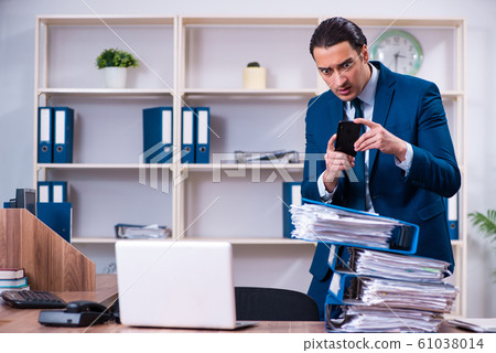 Young handsome businessman working in the office 61038014
