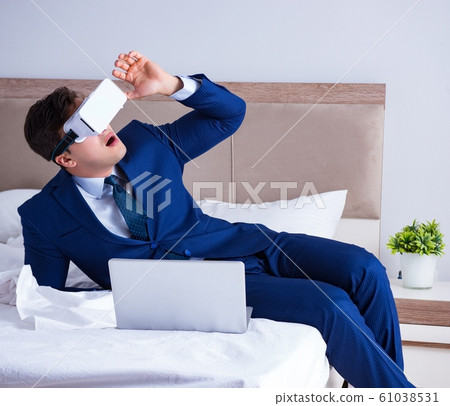 Businessman wearing a virtual reality headset in the bedroom 61038531