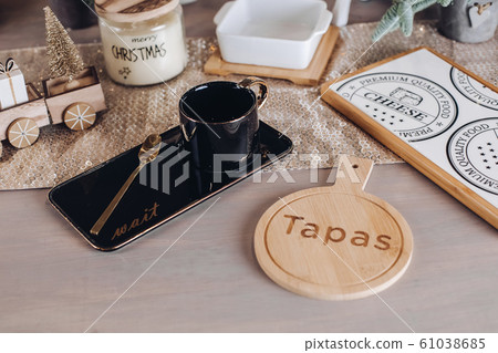 Ceramic drinking cup on a wooden table Ceramic drinking cup on a wooden table 61038685
