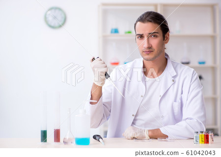 Young male chemist working in the lab 61042043