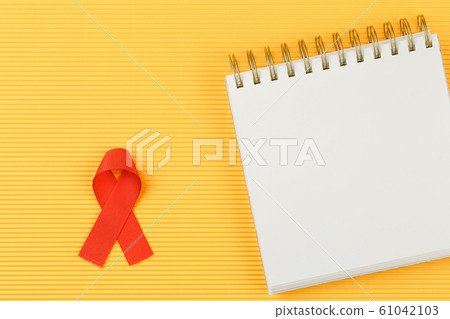 red aids ribbon on open notebook isolated red aids ribbon on open notebook isolated 61042103
