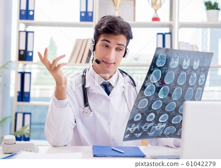 Young male doctor in telehealth concept 61042279