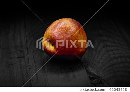 one nectarine green closeup black background one nectarine green closeup black background 61043328