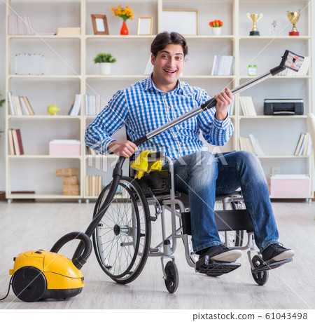 Disabled man cleaning home with vacuum cleaner 61043498