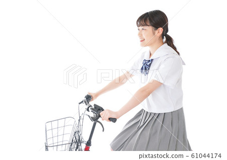 Young girl student going to school by bicycle 61044174