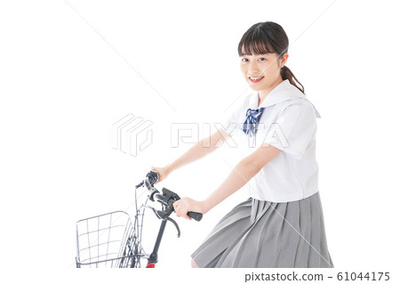 Young girl student going to school by bicycle Young girl student going to school by bicycle 61044175