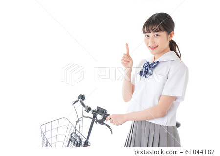 Young girl student going to school by bicycle 61044182
