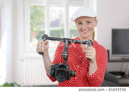 woman videographer using steady cam woman videographer using steady cam 61045556