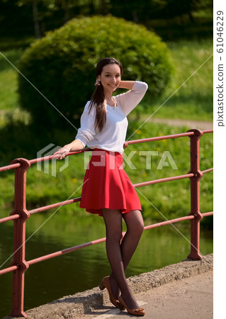 Portrait of a girl in red skirt and white blouse 61046229