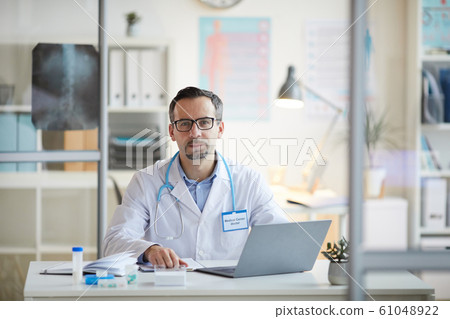 Doctor working at office Doctor working at office 61048922